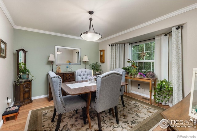 3023 39th Ave, Evans, CO 80620 - dining space featuring ornamental molding, wood finished floors, and baseboards