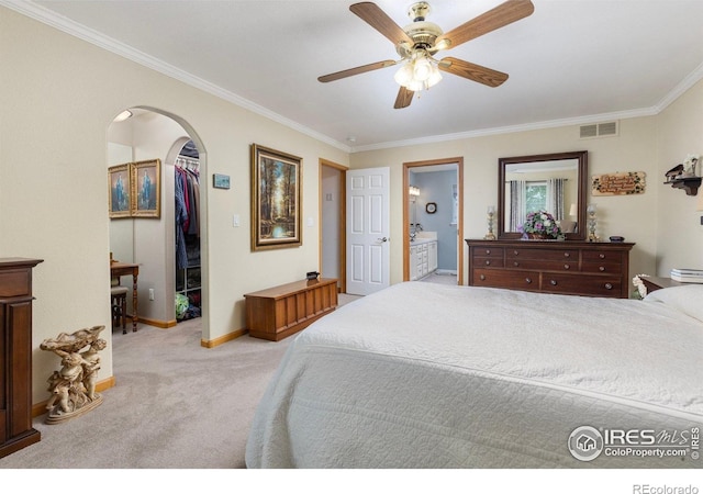 3023 39th Ave, Evans, CO 80620 - bedroom featuring ornamental molding, carpet floors, a walk in closet, arched walkways, and baseboards