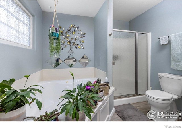 3023 39th Ave, Evans, CO 80620 - full bathroom with toilet, a stall shower, a garden tub, and wood finished floors
