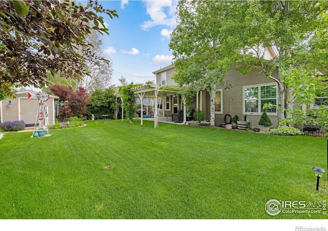 3023 39th Ave, Evans, CO 80620 - view of grassy yard featuring a pergola, a patio area, and an outbuilding