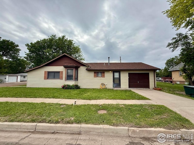 441 E Emerson St, Holyoke, CO 80734 - ranch-style house featuring an attached garage, driveway, and a front lawn