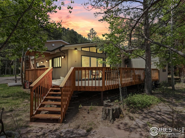135 Canyon River Rd, Drake, CO 80515 - back of property at dusk featuring stairs and a wooden deck