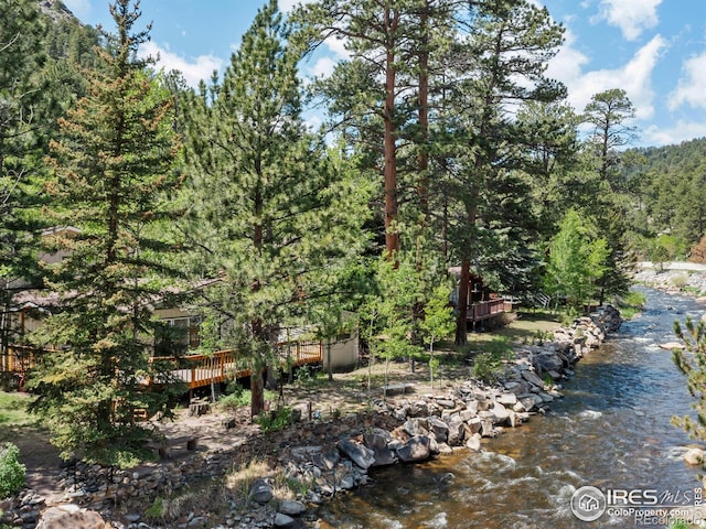 135 Canyon River Rd, Drake, CO 80515 - view of yard featuring a deck and a forest view