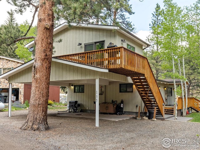 135 Canyon River Rd, Drake, CO 80515 - back of property with a deck and stairway