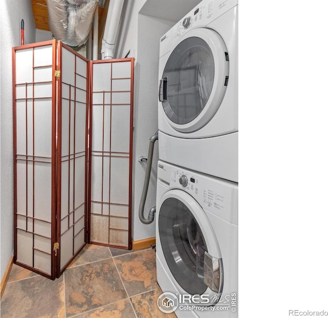 135 Canyon River Rd, Drake, CO 80515 - washroom with estacked washer and dryer, baseboards, and stone finish flooring