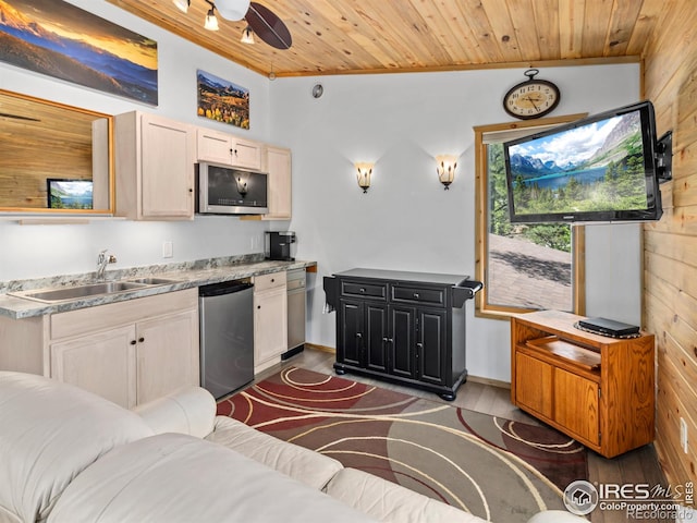 135 Canyon River Rd, Drake, CO 80515 - kitchen with fridge, a sink, crown molding, wood walls, and dark wood-style floors