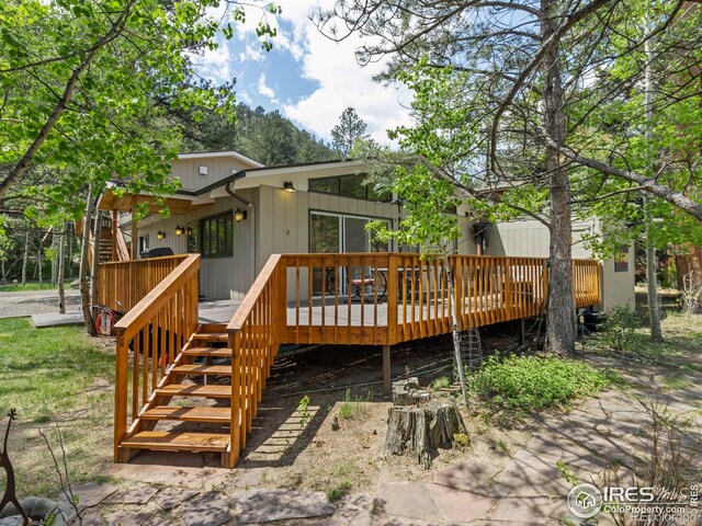 135 Canyon River Rd, Drake, CO 80515 - rear view of house with stairs and a wooden deck