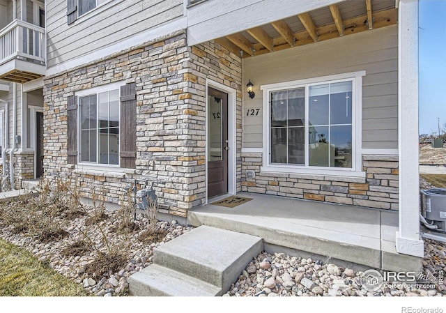 187 Robin Rd, Johnstown, CO 80534 - doorway to property featuring stone siding