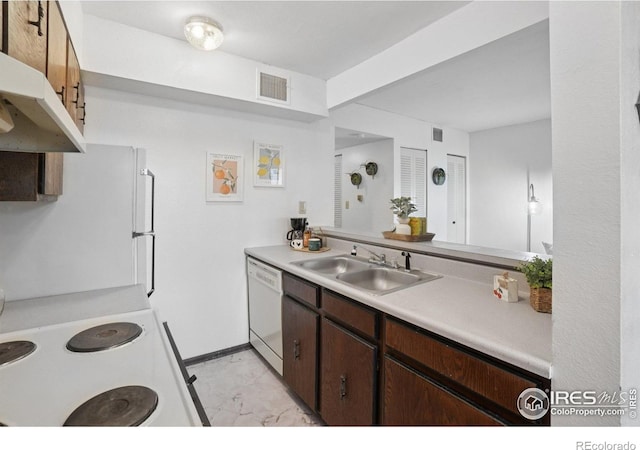 1705 Heatheridge Rd Unit G105, Fort Collins, CO 80526 - kitchen with white appliances, a sink, under cabinet range hood, light countertops, and light marble finish flooring