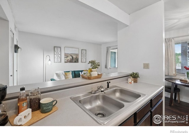 1705 Heatheridge Rd Unit G105, Fort Collins, CO 80526 - kitchen with a sink, light countertops, dark wood-style floors, and dark brown cabinetry
