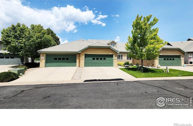 451 Clubhouse Ct, Loveland, CO 80537 - single story home with a tile roof, driveway, stucco siding, and an attached garage