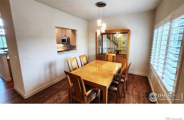 451 Clubhouse Ct, Loveland, CO 80537 - dining space featuring a chandelier, dark wood-style floors, and baseboards
