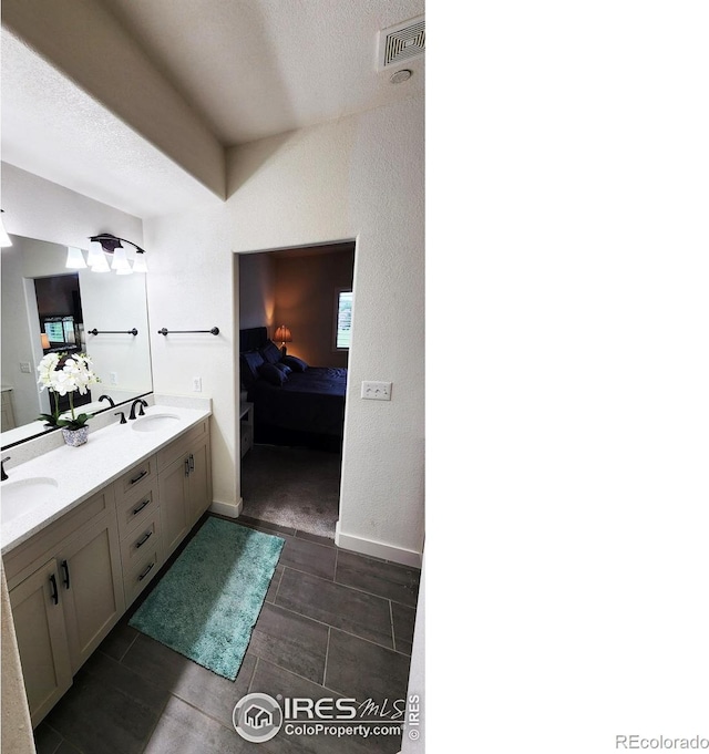 451 Clubhouse Ct, Loveland, CO 80537 - ensuite bathroom featuring double vanity and a textured ceiling