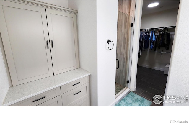 451 Clubhouse Ct, Loveland, CO 80537 - full bath featuring a shower stall, a spacious closet, and tile patterned flooring