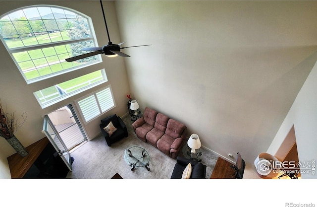451 Clubhouse Ct, Loveland, CO 80537 - unfurnished living room featuring a ceiling fan, carpet floors, and a towering ceiling