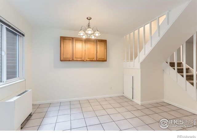 3161 Madison Ave Unit 108, Boulder, CO 80303 - unfurnished dining area featuring a chandelier, radiator heating unit, stairway, baseboards, and light tile patterned floors