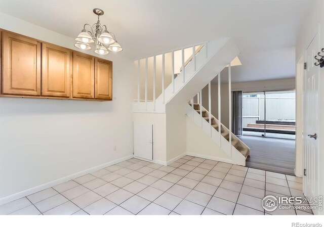3161 Madison Ave Unit 108, Boulder, CO 80303 - entryway with a chandelier, stairs, baseboards, and light tile patterned floors