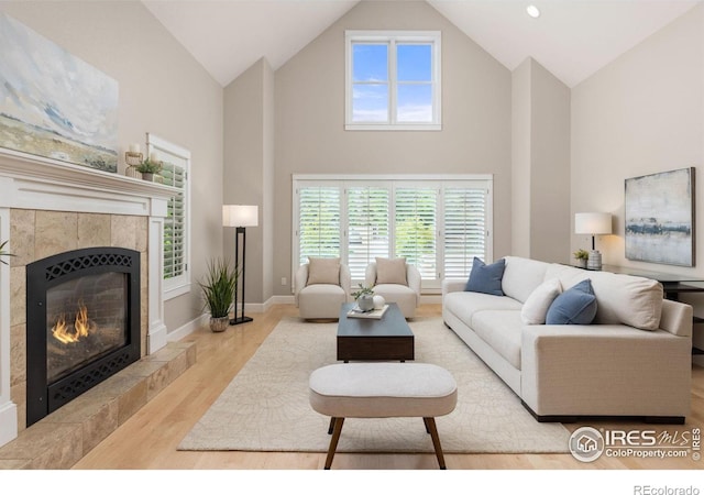 1509 Poplar Ave, Boulder, CO 80304 - living area with high vaulted ceiling, wood finished floors, a fireplace, and plenty of natural light