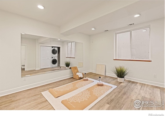 1509 Poplar Ave, Boulder, CO 80304 - exercise room featuring stacked washer and clothes dryer, wood finished floors, and recessed lighting
