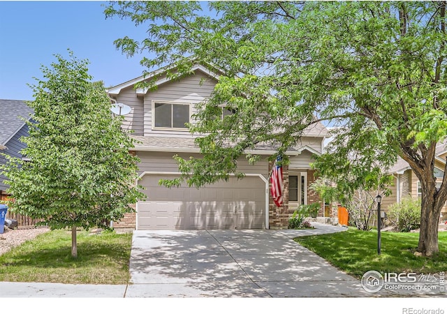 379 E 41st Ct, Loveland, CO 80538 - obstructed view of property featuring concrete driveway, a garage, brick siding, and a front yard