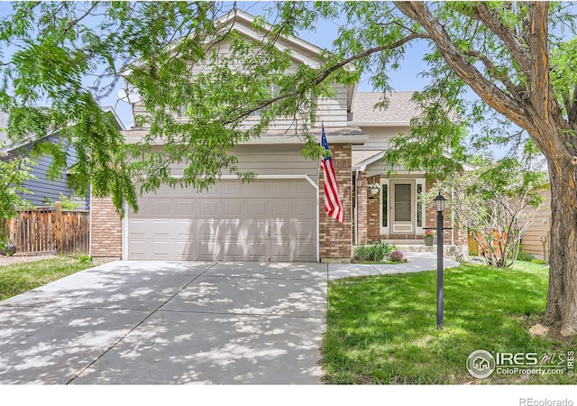 379 E 41st Ct, Loveland, CO 80538 - view of front of house with concrete driveway, brick siding, a garage, and roof with shingles