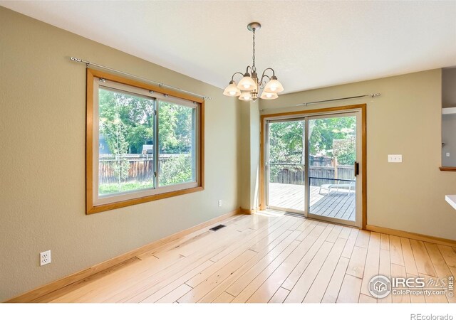 379 E 41st Ct, Loveland, CO 80538 - spare room with a chandelier, light wood-style flooring, and baseboards