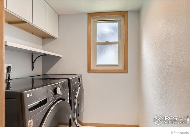 379 E 41st Ct, Loveland, CO 80538 - laundry area featuring cabinet space, washing machine and dryer, and a textured wall