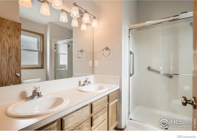 379 E 41st Ct, Loveland, CO 80538 - full bath featuring a shower stall, double vanity, and toilet