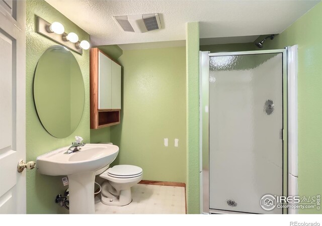 379 E 41st Ct, Loveland, CO 80538 - full bath with a stall shower, toilet, and tile patterned floors