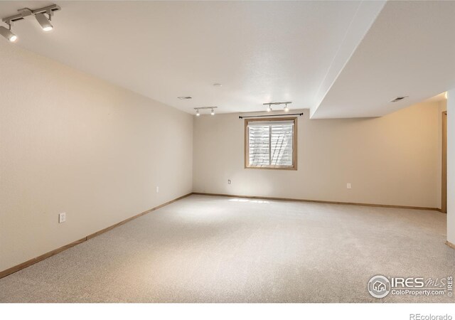 379 E 41st Ct, Loveland, CO 80538 - unfurnished room featuring track lighting, light carpet, and baseboards