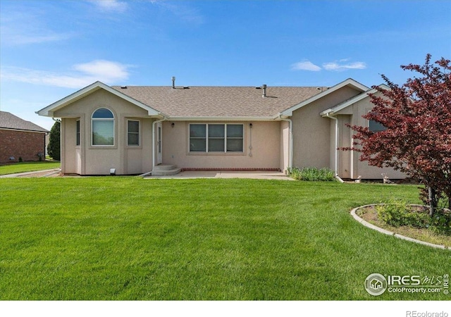 1365 Settlers Dr, Eaton, CO 80615 - view of front facade featuring stucco siding, a front lawn, and roof with shingles
