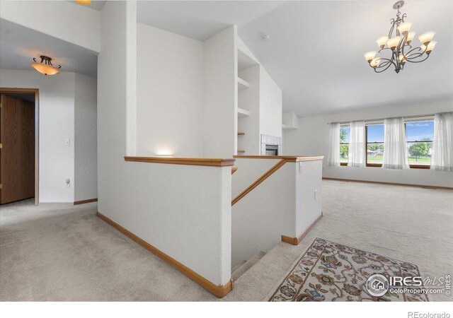 1365 Settlers Dr, Eaton, CO 80615 - hallway with light carpet and a chandelier