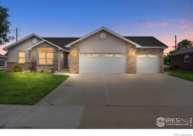 1365 Settlers Dr, Eaton, CO 80615 - ranch-style house featuring a garage, concrete driveway, a front yard, and brick siding