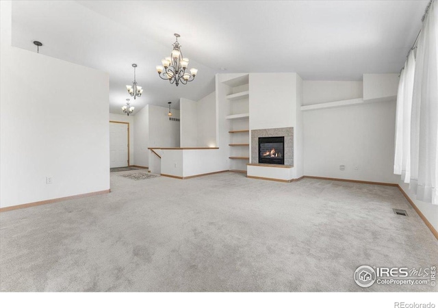 1365 Settlers Dr, Eaton, CO 80615 - unfurnished living room with a chandelier, carpet flooring, lofted ceiling, and a tiled fireplace