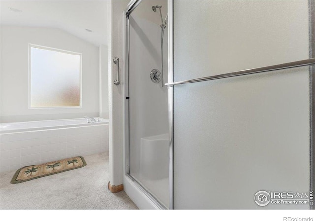 1365 Settlers Dr, Eaton, CO 80615 - bathroom featuring a shower stall, a garden tub, and lofted ceiling