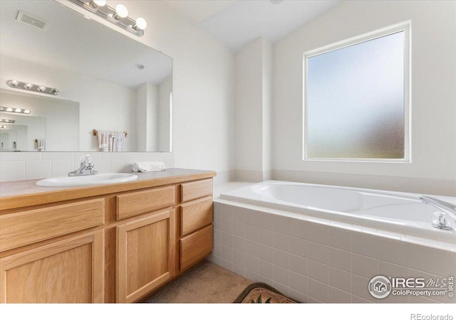 1365 Settlers Dr, Eaton, CO 80615 - bathroom featuring vanity, a garden tub, and tasteful backsplash