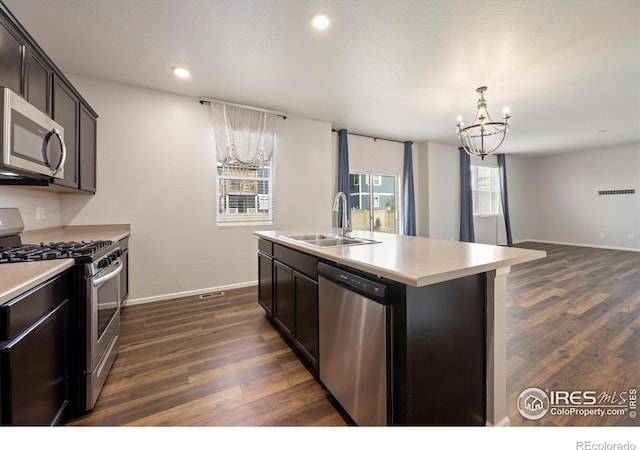 6793 Hayfield St, Wellington, CO 80549 - kitchen featuring stainless steel appliances, a sink, a chandelier, dark wood-type flooring, and recessed lighting
