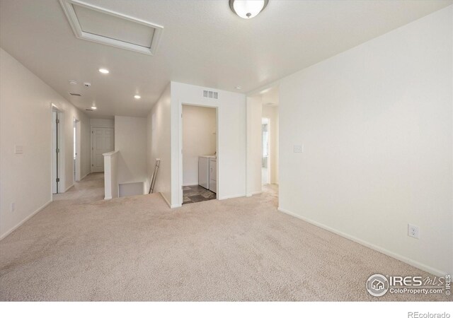 6793 Hayfield St, Wellington, CO 80549 - carpeted spare room featuring independent washer and dryer, attic access, recessed lighting, and baseboards
