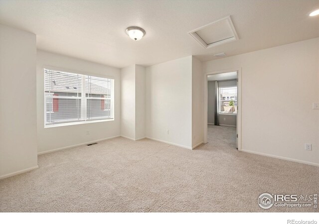6793 Hayfield St, Wellington, CO 80549 - empty room with carpet, baseboards, and attic access
