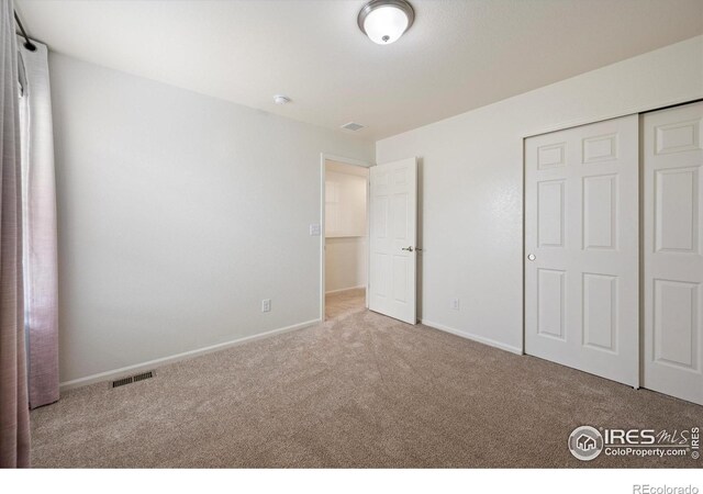 6793 Hayfield St, Wellington, CO 80549 - unfurnished bedroom with carpet flooring, baseboards, and a closet