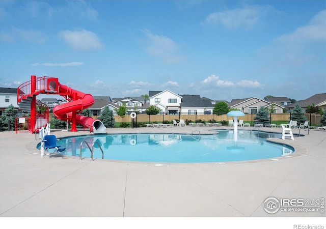 6793 Hayfield St, Wellington, CO 80549 - community pool with a water slide, a patio area, and a residential view