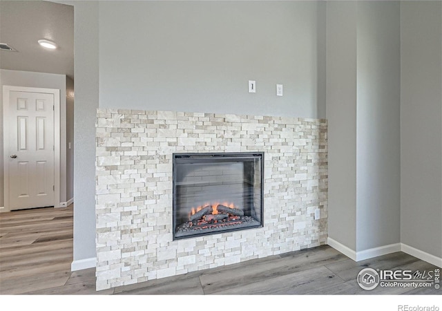 2435 Calais Dr Unit G, Longmont, CO 80504 - detailed view of wood finished floors, baseboards, a stone fireplace, and recessed lighting