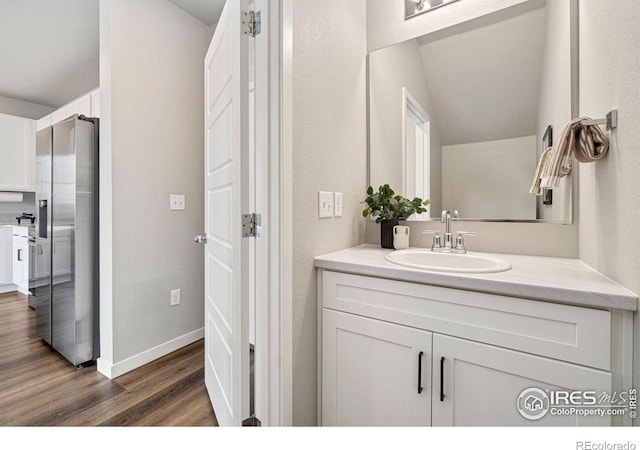 259 Molinar St, Johnstown, CO 80534 - bathroom featuring wood finished floors, vanity, and baseboards