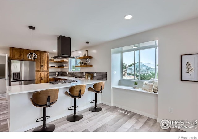 128 Carpenter Rd, Fort Collins, CO 80525 - kitchen with stainless steel fridge with ice dispenser, island range hood, open shelves, light countertops, and light wood-style flooring