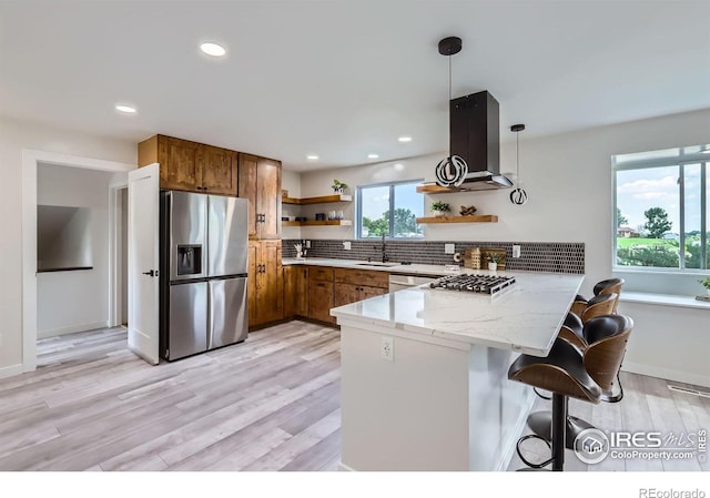 128 Carpenter Rd, Fort Collins, CO 80525 - kitchen with appliances with stainless steel finishes, open shelves, a peninsula, brown cabinetry, and light wood finished floors