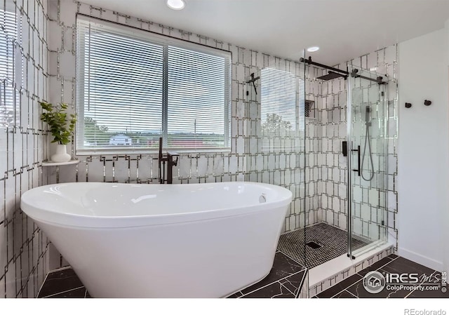 128 Carpenter Rd, Fort Collins, CO 80525 - full bathroom with a freestanding tub, a stall shower, tile patterned floors, recessed lighting, and tile walls