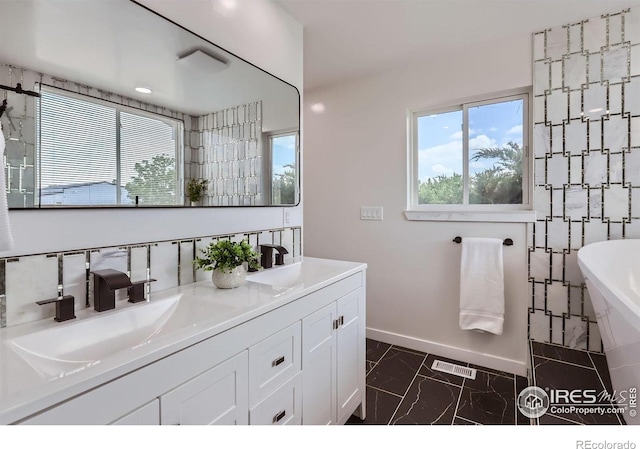 128 Carpenter Rd, Fort Collins, CO 80525 - full bath with a freestanding bath, marble finish floors, baseboards, and double vanity