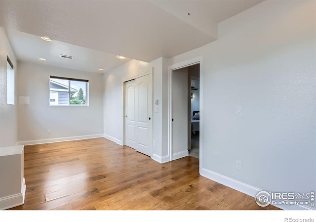 128 Carpenter Rd, Fort Collins, CO 80525 - unfurnished bedroom with wood finished floors, baseboards, a closet, and recessed lighting