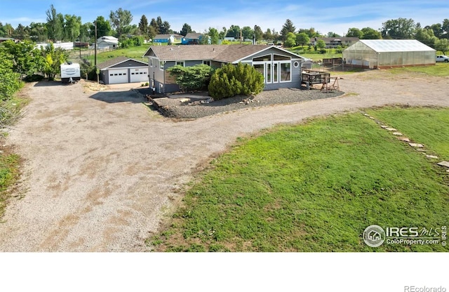 128 Carpenter Rd, Fort Collins, CO 80525 - view of front of house with an exterior structure, an outbuilding, driveway, and a detached garage