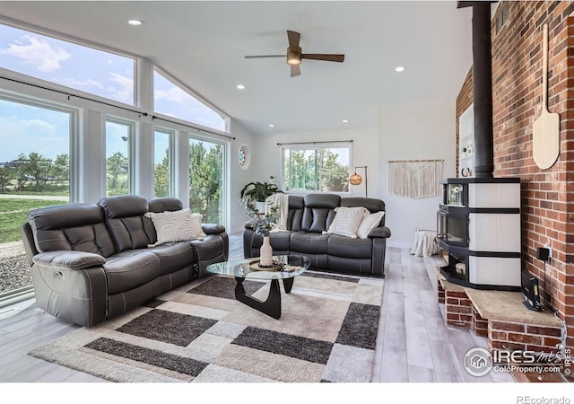 128 Carpenter Rd, Fort Collins, CO 80525 - living room featuring hardwood / wood-style floors, ceiling fan, a wood stove, vaulted ceiling, and recessed lighting
